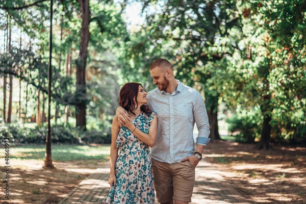 Fototapeta Beautiful young couple in park. Love and emotions concept.