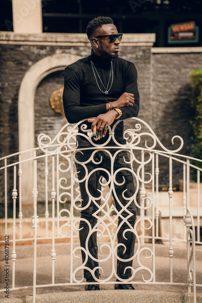 Fototapeta portrait of african model smoking cigar and posing for photography