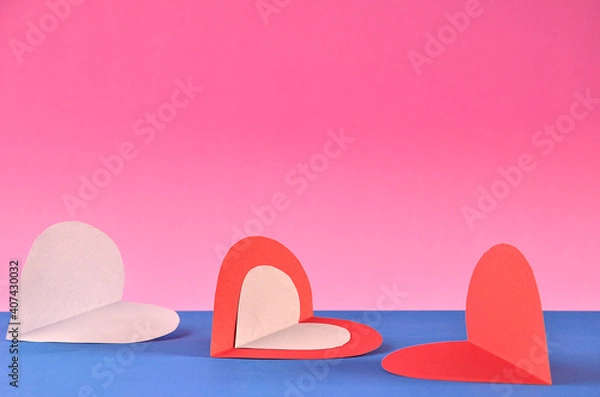 Fototapeta three hearts with pink background and space for text