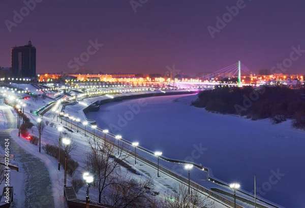 Obraz Winter evening in Tyumen. High embankment of the Tura River in the night lights