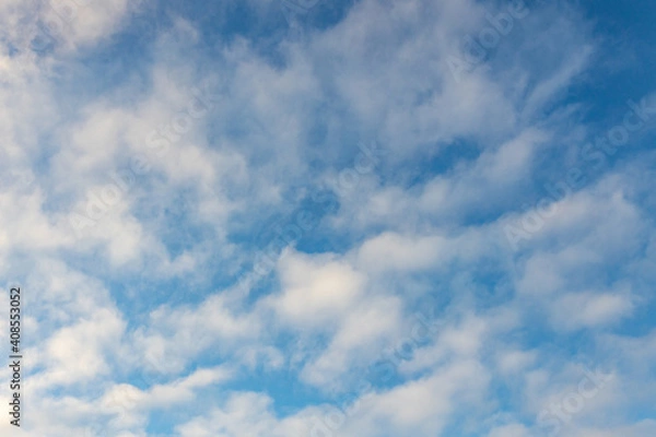 Fototapeta High white cirrus clouds with cirro-stratus in a light blue sky, sometimes called chair tails, indicate nice weather, but stormy changes come within a few days. White clouds in a blue sky. 