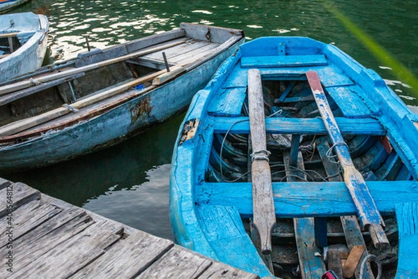 Fototapeta Heavily used blue boat on a canal for daily local work.