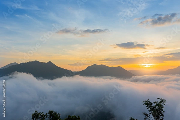 Fototapeta The beautiful view of the sunrise against the sea of mist at Phu Tok, Loei, Thailand.