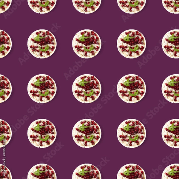 Fototapeta Seamless pattern from galettHealthy breakfast with rice cake and pomegranate on violet flat lay.