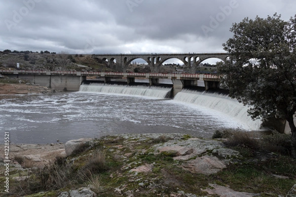 Fototapeta Fuentes claras' dam, at the end of the winter, full of water flooding