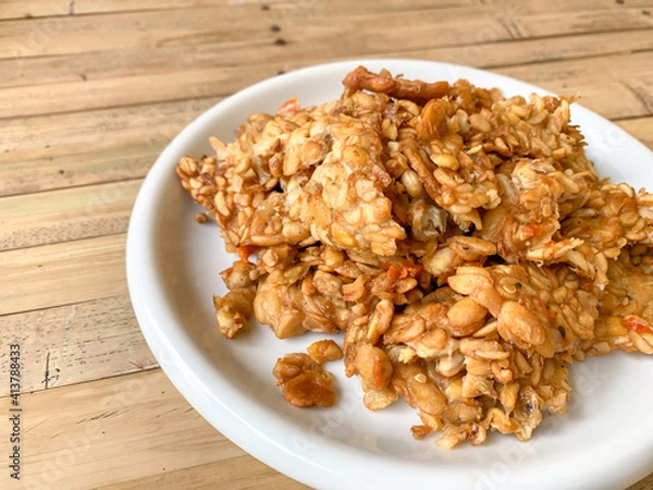 Fototapeta fried tempeh (tempeh penyet) in a white plate.