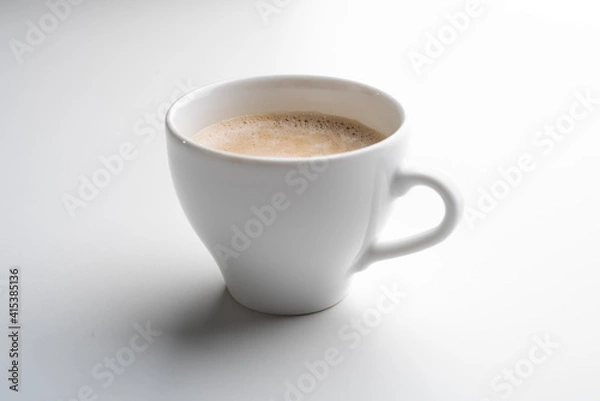 Obraz White cup of coffee in soft light isolated on a white background. Cappuccino coffee. 