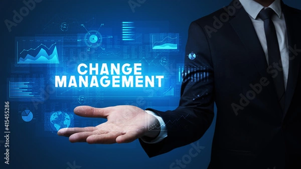 Fototapeta Hand of Businessman holding CHANGE MANAGEMENT inscription, business success concept