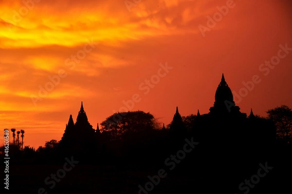 Fototapeta View landscape with silhouette chedi stupa of Bagan or Pagan ancient city and UNESCO World Heritage Site with over 2000 pagodas and temples evening twilight dusk time in Mandalay Region of Myanmar