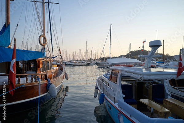 Fototapeta Yachts and boats in harbor at Mediterranean sea. Beautiful sea port with assorted of boats. Bodrum, Turkey.