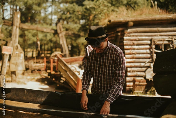 Fototapeta The man found gold. Contemporary lucky prospector found lot of gold in creek when panning sand.