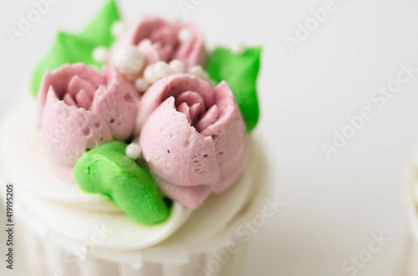 Fototapeta Tender cake with whipped cream. Cake in the form of flowers. Cupcake with whipped cream.