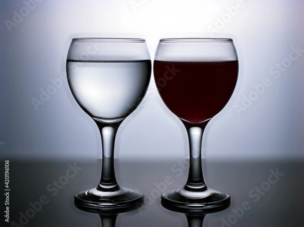 Obraz Glass of water isolated in black and white image for background ,glass of wine ,dinner ware ,glass of red wine