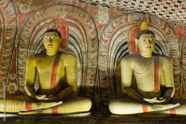 Fototapeta At Dambulla, Sri Lanka, the caves of the Royal Rock Temple complex are filled with Buddha images and murals.