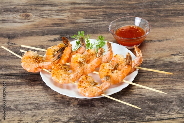 Fototapeta Grilled prawn skewer with sauce