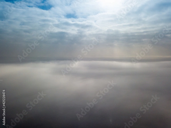 Fototapeta Aerial high view. Flying over the clouds.