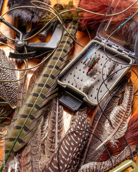 Fototapeta Fly Fishing Still Life. Materials and tools for tying lures on a wooden table. Hobby concept.