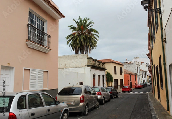 Fototapeta Tenerife. Colourful houses and house with unusual balconies on street in Puerto de la Cruz town, Tenerife, Canary Islands, Spain