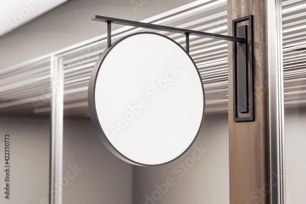 Obraz Blank white round street sign in dark iron frame on dark wooden post at the entrance. Mockup