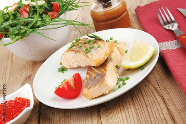 Fototapeta baked salmon strips with green vegetable salad and tomatoes