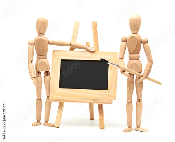 Fototapeta Wooden artist mannequin with brush in pose with wood frame