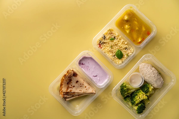 Fototapeta Weight loss diet balanced with fresh organic meal by delivery service of containers with healthy food, daily lunch box ready menu plan concept. Flat lay top view.