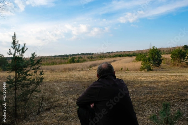 Obraz Alone aged man enjoys the silence in the wild at sunset. Copy space. 