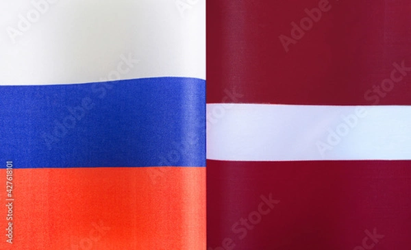 Fototapeta fragments of the national flags of Russia and Latvia close-up