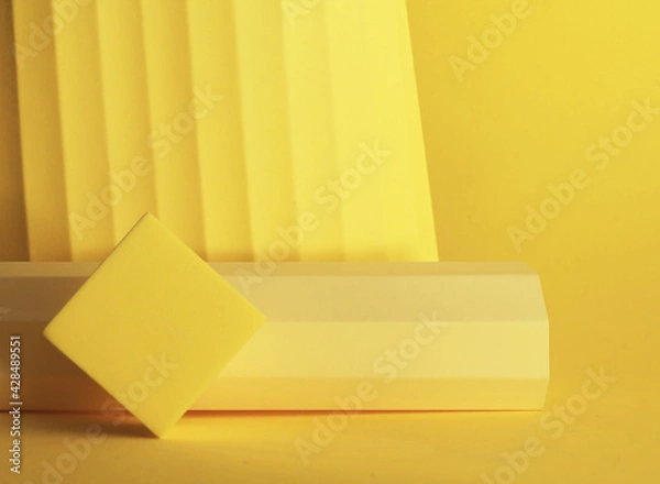 Fototapeta Podium in yellow color with geometric shapes. Stage with concrete, plaster geometric geometric shapes.