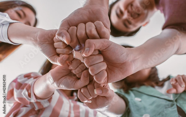 Fototapeta Selective focus and closeup on hands together showing unity and successful teamwork in job.