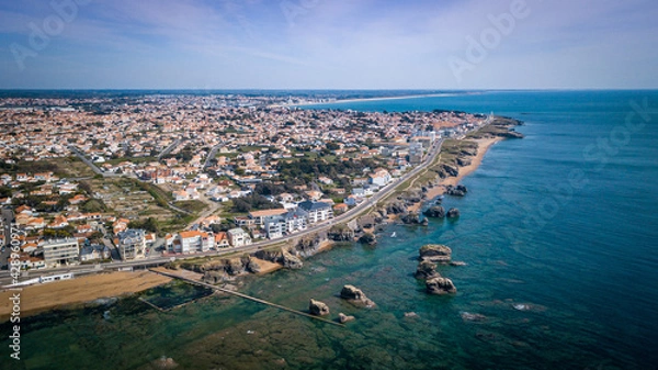 Fototapeta Aerial view from a magnificent coastline between cliffs, beaches, clear water and city. That place is called "Les 5 pineaux" located in Saint-Hilaire-de-Riez, France