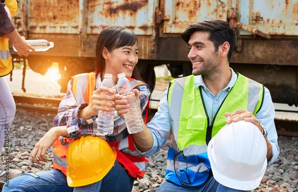 Obraz Industrial workers sit and drink water.