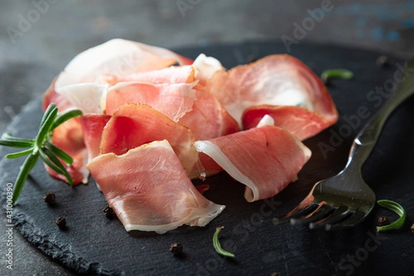 Fototapeta Pieces of prosciutto or jamon close up