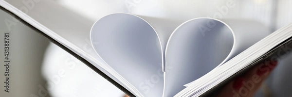 Fototapeta Sheets in diary are folded into heart shape