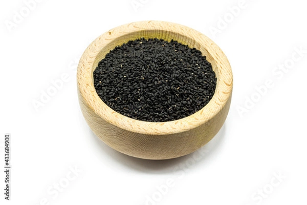 Fototapeta Real black cumin in wooden bowl isolated on white background