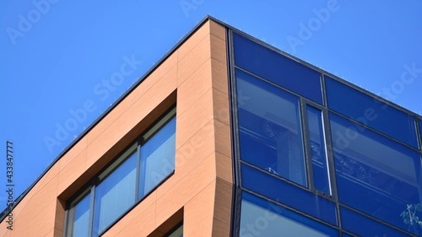 Fototapeta Mirrored windows of the facade of an office building. Abstract texture of blue glass modern office building. Business background.