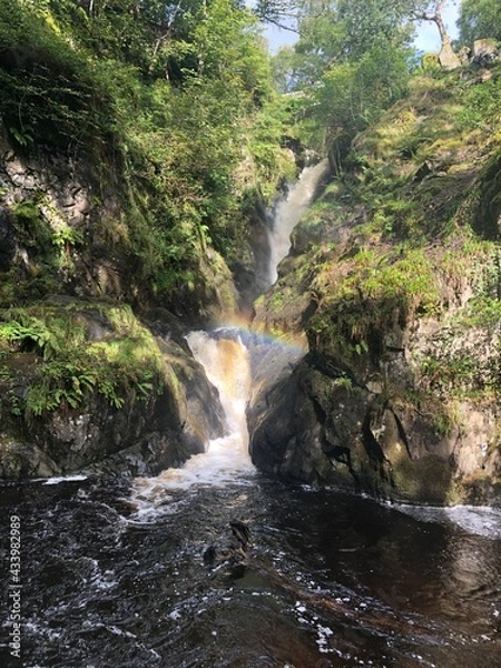 Fototapeta Lake District, rainbow over a beautiful natural waterfall.