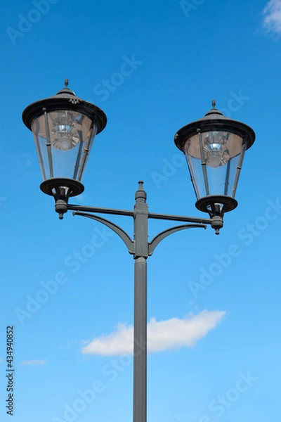 Fototapeta Vintage street lamp isolated against blue sky