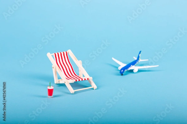 Obraz Beach chairs isolated on blue background and an aeroplane