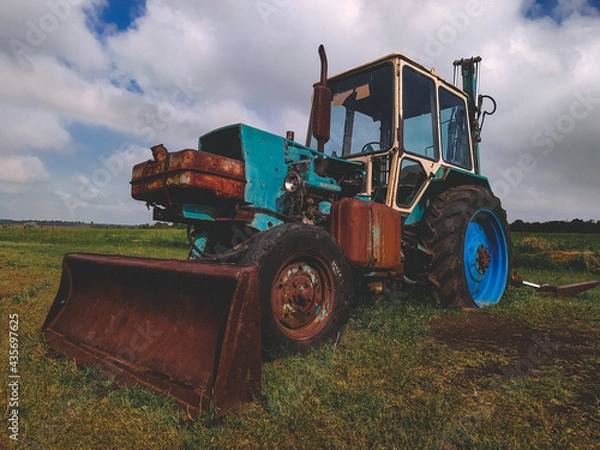 Fototapeta old tractor in the field