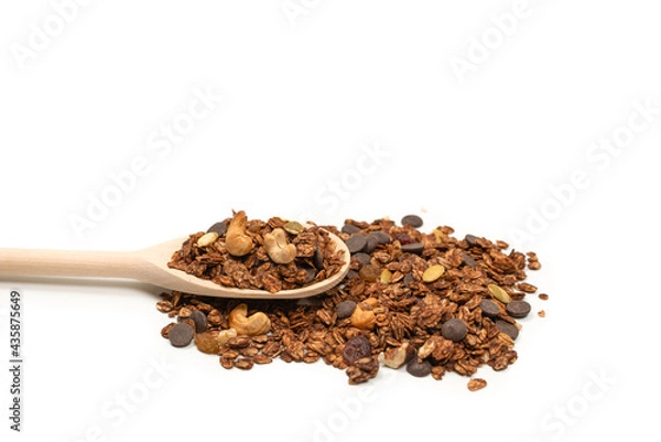 Obraz Chocolate granola cereal with nuts in a wooden spoon.