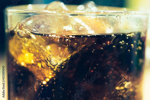 Fototapeta Refreshing Bubbly Soda Pop with Ice Cubes. Cold soda iced drink in a glasses - Selective focus, shallow DOF	
