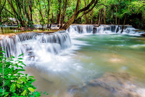 Obraz Waterfall and blue emerald water color in Huay Mae Khamin national park. Huay Mae Khamin, Beautiful nature rock waterfall steps in tropical rainforest at Kanchanaburi province, Thailand