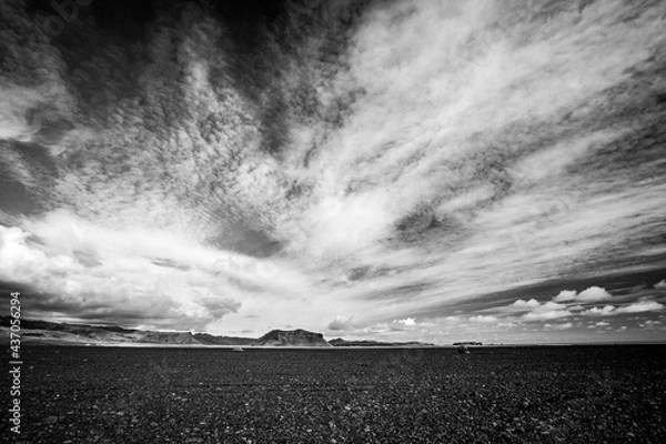 Fototapeta Black and white minimalistic landscape of the black volcanic desert in Southern Iceland, dramatic sky, high contrast