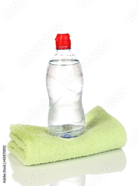 Fototapeta plastic bottle of water on towel isolated on white