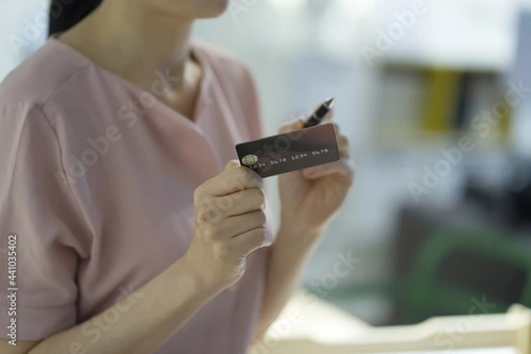 Fototapeta Woman shopping with credit card in store