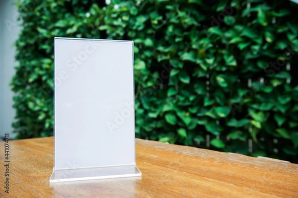 Fototapeta Mock up Menu frame standing on wood table in Bar restaurant cafe. space for text. Menu mack up blank for text marketing promotion