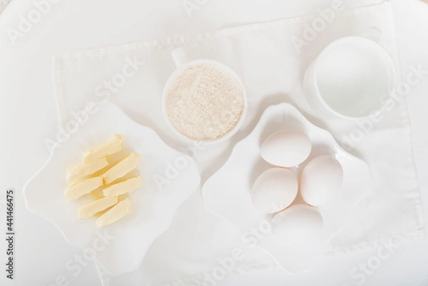 Fototapeta Top view on butter, flour and butter for dough. Preparing for baking. Recipe ingredients