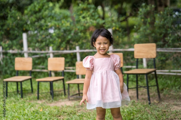 Obraz Smiling little Asian girl standing outdoor.