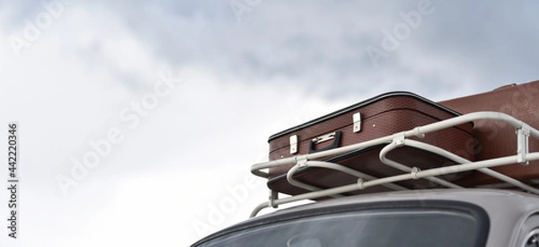 Fototapeta trip on retro car with suitcases on roof rack